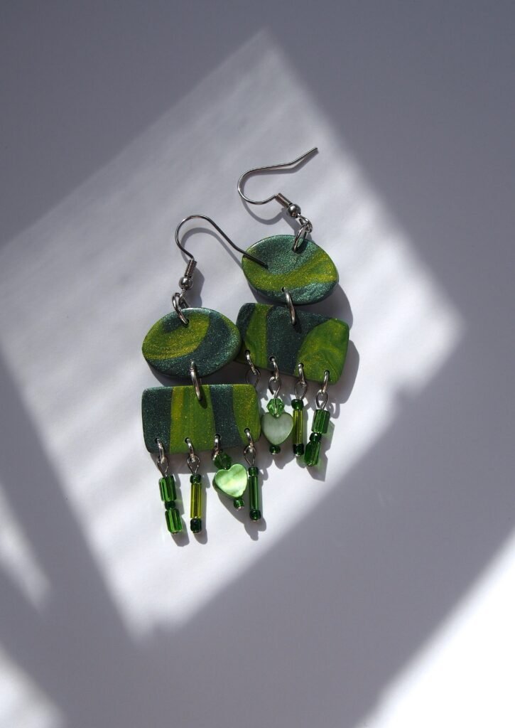Green bohemian earrings handmade from polymer clay. Moss green boho earrings featuring gentle sparkling beads and subtle geometric shapes, ideal as faecore jewelry or an artistic, nature-inspired gift for her. Unique green earrings fit for a forest fairy.